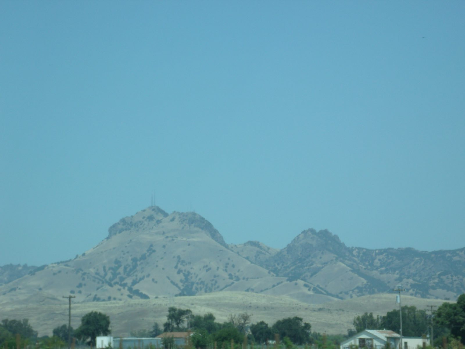 The Sutter Buttes rising behind homes in Sutter County